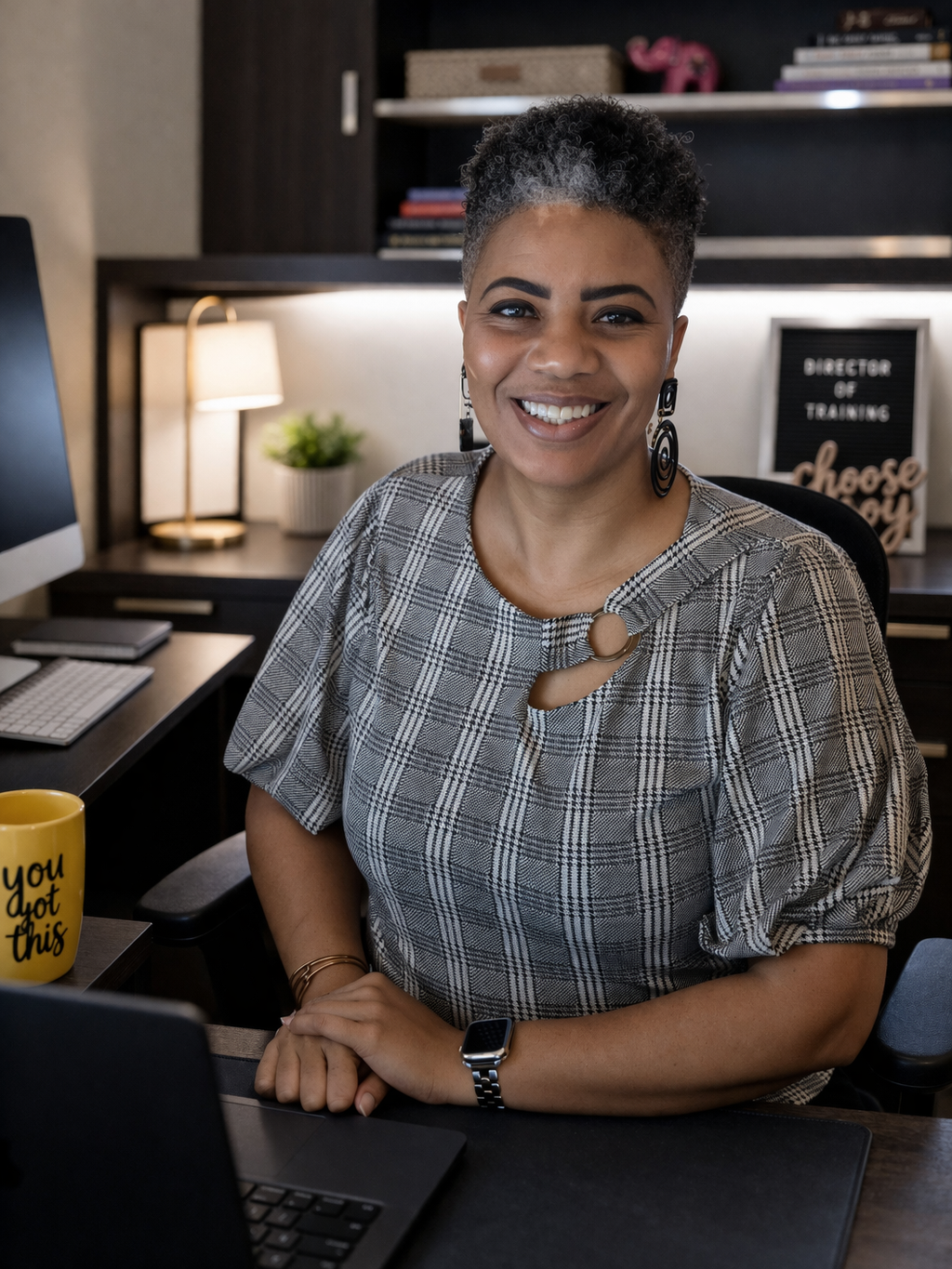 Bianca Young, Director of Training at Magdala House, smiling at her desk in a professional office setting