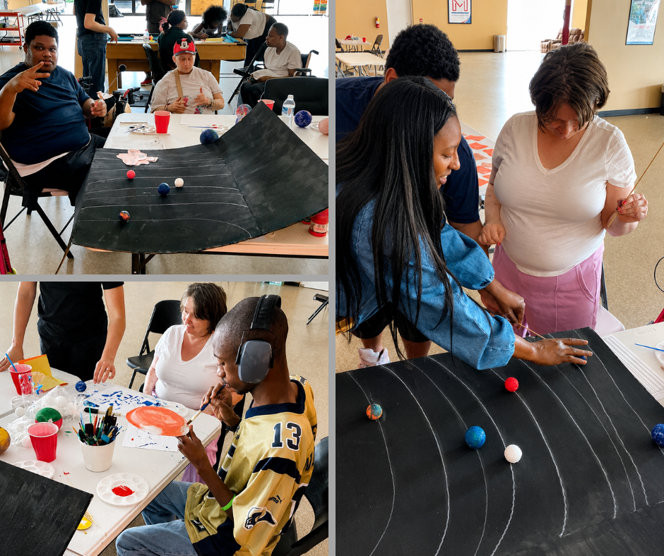 Adult Day Care Program clients painting and placing planets on a handmade solar system model at Magdala House